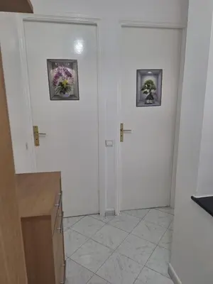 a white room with two pictures on the wall at Appartement cosy à Rabat Mer et commodités à pied in Rabat