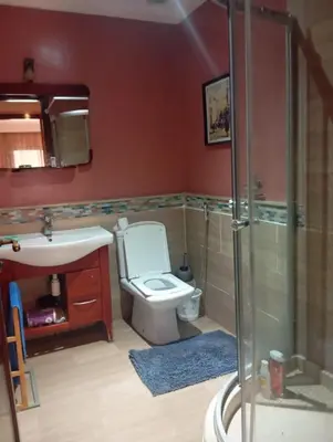 a bathroom with a toilet and a sink and a shower at Beach apartment with pool Skhirat beach in Skhirat