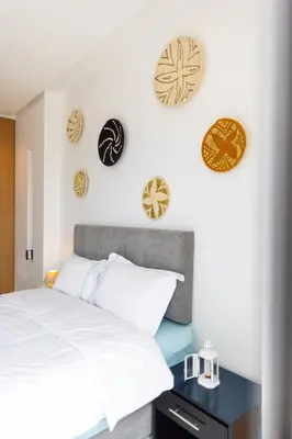 a bedroom with a bed and plates on the wall at APGCI -Studio Élégant a 5 min du Stade Mohamed V in Casablanca