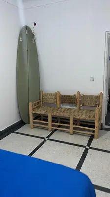 two wooden benches sitting in a room at Villa Haryouli in Azemmour