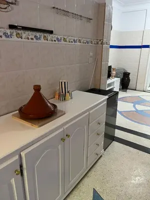 a kitchen with white cabinets and a counter top at Villa Haryouli in Azemmour