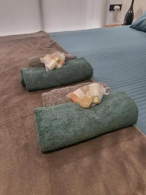 two beds with towels and two shoes on them at O'Blu Pearl Casablanca Center, Morocco in Casablanca