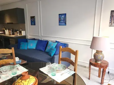 a living room with a couch and a table and chairs at O'Blu Pearl Casablanca Center, Morocco in Casablanca