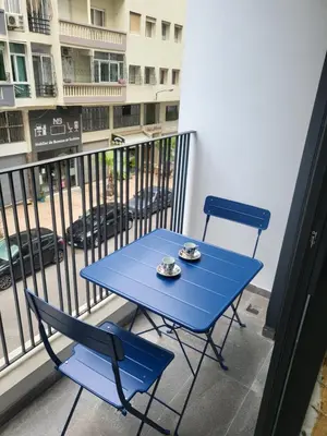 a blue table and two chairs on a balcony at O'Blu Pearl Casablanca Center, Morocco in Casablanca