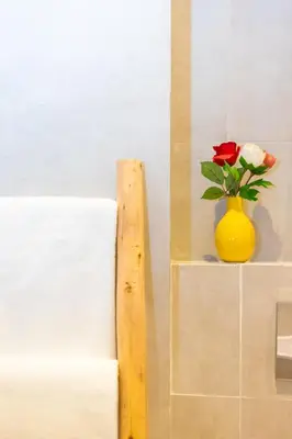 a yellow vase with a flower on a shelf at Luxury central Apartment - 3BR - Flipper - Parking in Casablanca
