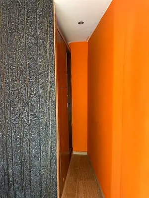an empty corridor with orange walls and a door at Studio cosy et abordable in Casablanca