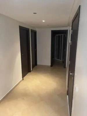 an empty hallway with black doors and a tile floor at Magnifique Appartement à Louer C14 Jnane Dalya in Bouznika