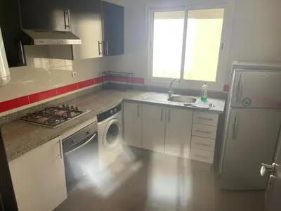 a kitchen with a sink and a washing machine at Magnifique Appartement à Louer C14 Jnane Dalya in Bouznika