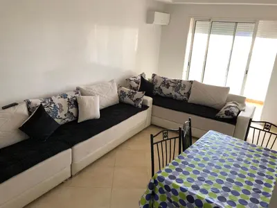 a living room with a couch and a bed at Magnifique Appartement à Louer C14 Jnane Dalya in Bouznika
