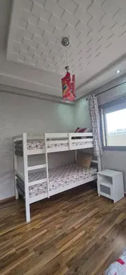 a room with two bunk beds and a window at appartement luxe dt3 in Mohammedia