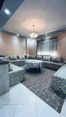 a large living room with couches and a chandelier at appartement calme dt4 in Mohammedia