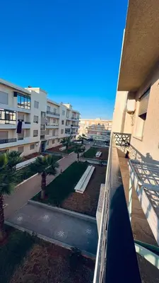 a view of a park from a balcony of a building at appartement calme dt4 in Mohammedia