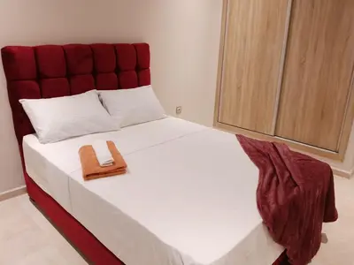 a bedroom with a large bed with a wooden headboard at Les belles loges in Bouskoura
