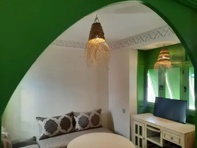 a living room with a couch and a mirror at Casitademama in Sidi Yahia az Zaʼer
