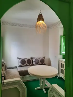 a living room with a table and a couch at Casitademama in Sidi Yahia az Zaʼer
