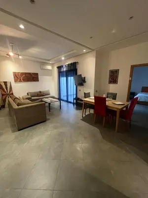 a living room with a couch and a table at Appart hôtel las jemelas in Casablanca