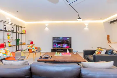 a living room with a couch and a table at Casablanca City Center Loft, 3 BR, Parking, AC & Terrasse in Casablanca