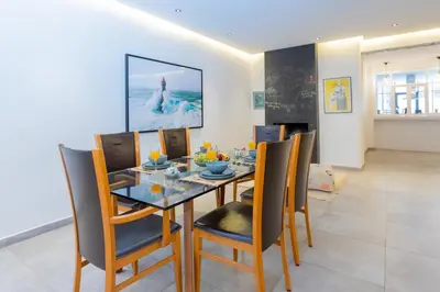 a dining room with a glass table and chairs at Casablanca City Center Loft, 3 BR, Parking, AC & Terrasse in Casablanca