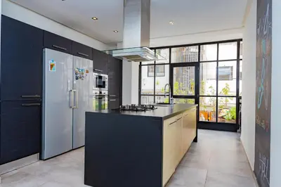 a kitchen with a black counter top and a refrigerator at Casablanca City Center Loft, 3 BR, Parking, AC & Terrasse in Casablanca