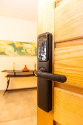 a cell phone sticking out of a wooden door at Casablanca City Center Loft, 3 BR, Parking, AC & Terrasse in Casablanca