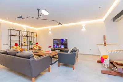 a living room with a couch and a table at Casablanca City Center Loft, 3 BR, Parking, AC & Terrasse in Casablanca