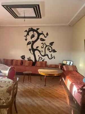 a living room with a couch and a table at Villa dar deyafa jamaat fedalat in Sidi Moussa Ben Ali