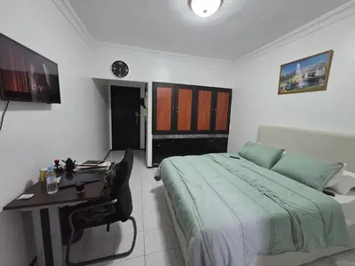 a bedroom with a bed and a desk in it at Studio Rabat in Rabat