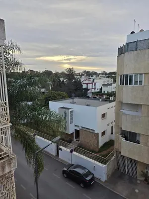 a black car parked in a parking lot next to a building at Studio Rabat in Rabat