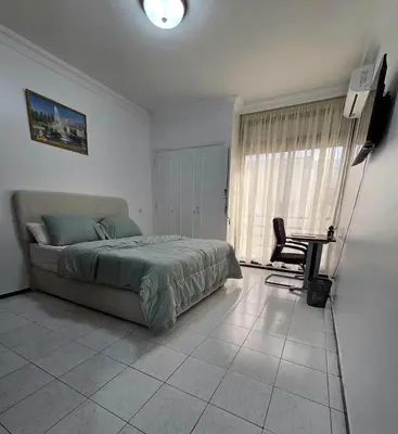 a bedroom with a bed and a desk in it at Studio Rabat in Rabat