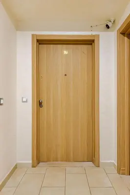 a wooden door in a room with a tile floor at 2ch au Centre de Mohammedia Parc in Mohammedia