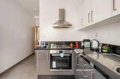 a kitchen with a sink and a stove top oven at 2ch au Centre de Mohammedia Parc in Mohammedia