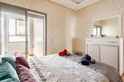 a bedroom with a large bed with pillows on it at 2ch au Centre de Mohammedia Parc in Mohammedia
