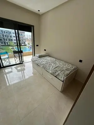 a bedroom with a bed in a room with a large window at 3 bedrooms in El Mansouria with pool beach terrace in Pont Blondin
