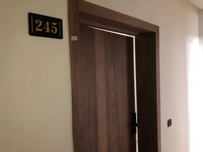 a wooden door with a clock on the wall at 3 bedrooms in El Mansouria with pool beach terrace in Pont Blondin