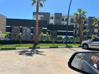a side view mirror of a car in front of a building at 3 bedrooms in El Mansouria with pool beach terrace in Pont Blondin