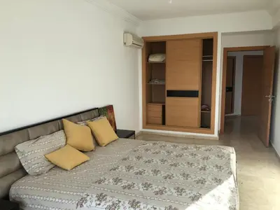 a bedroom with a bed with yellow pillows on it at Park Plaza studio quiet comfort No one opposite in Mohammedia