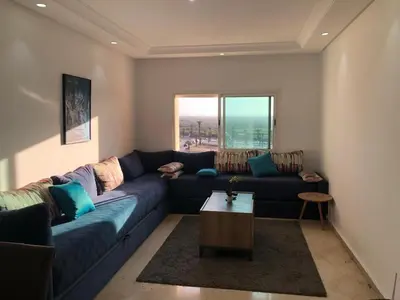 a living room with a blue couch and a table at Park Plaza studio quiet comfort No one opposite in Mohammedia
