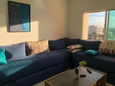 a blue couch in a living room with a table at Park Plaza studio quiet comfort No one opposite in Mohammedia