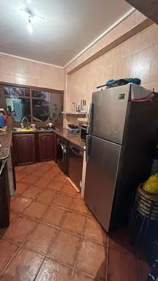 a kitchen with a stainless steel refrigerator in it at Appartement Moderne et Lumineux in Rabat