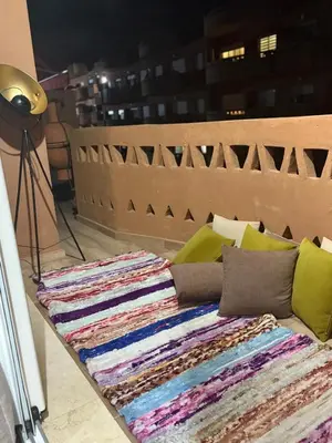 a pile of blankets sitting on top of a couch at Nice apartment with terrace overlooking pool in O Ben Slimane