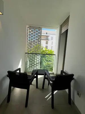 a room with two chairs and a table and a window at Modern 1BR Orangeraie - Terrace & Pool in Rabat