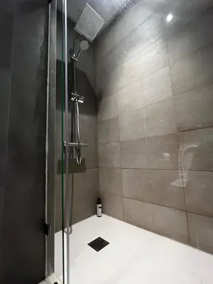 a shower with a glass door in a bathroom at Modern 1BR Orangeraie - Terrace & Pool in Rabat