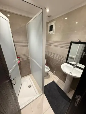 a bathroom with a shower and a sink and a toilet at Modern apartment in Rabat, Temara in Temara