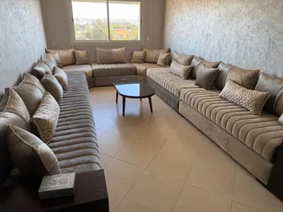 a living room with a large couch and a table at Modern apartment in Rabat, Temara in Temara