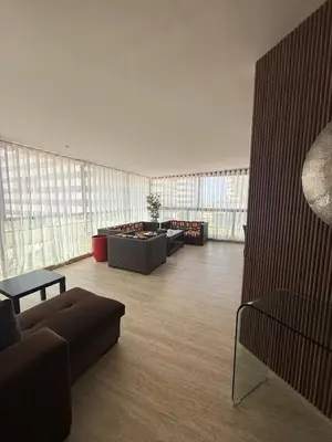 a large room with couches and tables and windows at Beautiful Ocean view Marina Casablanca in Casablanca