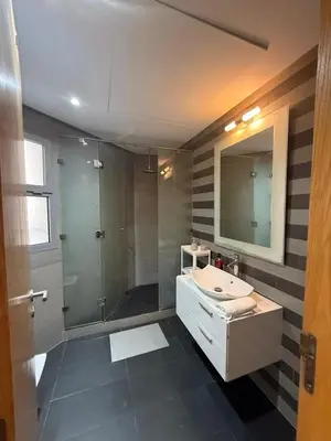 a bathroom with a shower and a sink and a mirror at Beautiful Ocean view Marina Casablanca in Casablanca