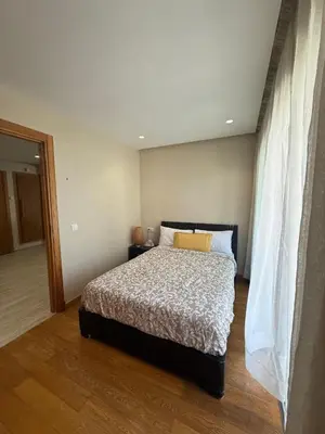 a bedroom with a bed with a white comforter at Beautiful Ocean view Marina Casablanca in Casablanca