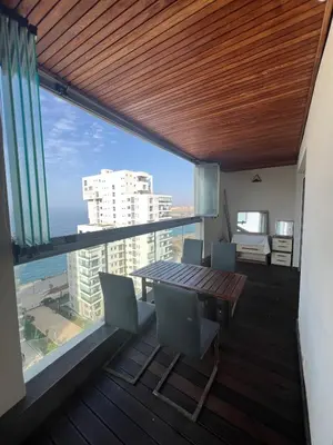 a balcony with a table and chairs and a view of the ocean at Stunning Marina high floor ocean view in Casablanca