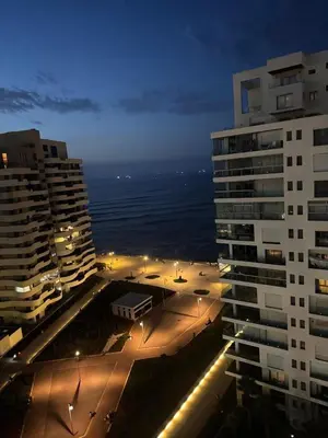 a view of a city at night with buildings at Stunning Marina high floor ocean view in Casablanca
