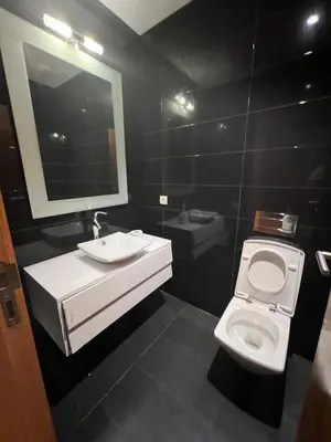 a bathroom with a toilet and a sink and a mirror at Stunning Marina high floor ocean view in Casablanca